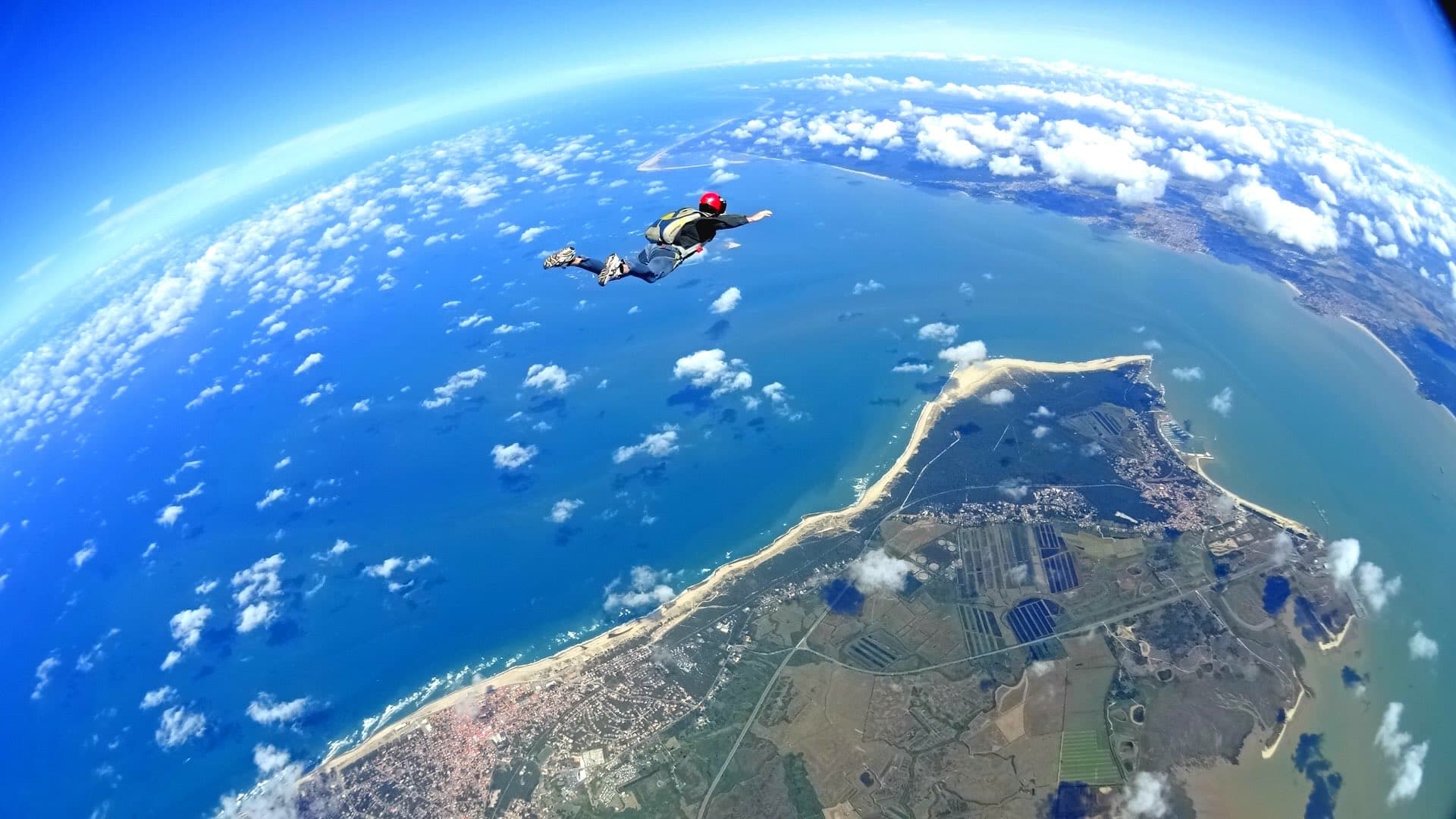 Photo of Anthony, the owner of the website, during a skydive jump with the ocean in the background